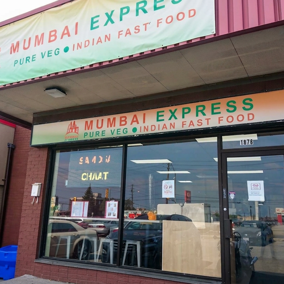 Exterior storefront of Mumbai Express, a pure vegetarian Indian fast-food restaurant, with two people walking beside the entrance.